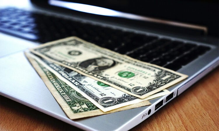 Digital icons representing online earning methods on a laptop screen.