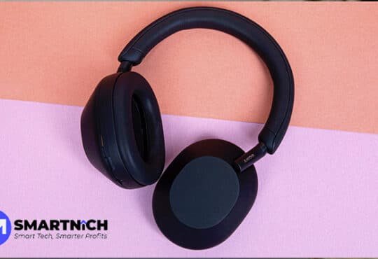 Sony WH-1000XM5 wireless noise-canceling headphones in black on a minimalist white desk.