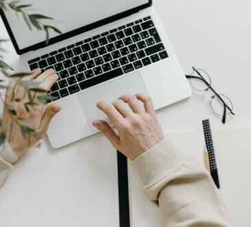 Person working remotely on a laptop in a flexible workspace
