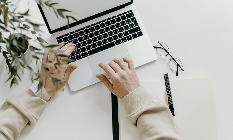 Person working remotely on a laptop in a flexible workspace