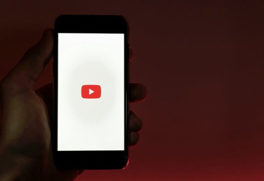Laptop showing faceless YouTube channel making passive income