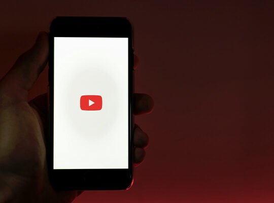 Laptop showing faceless YouTube channel making passive income