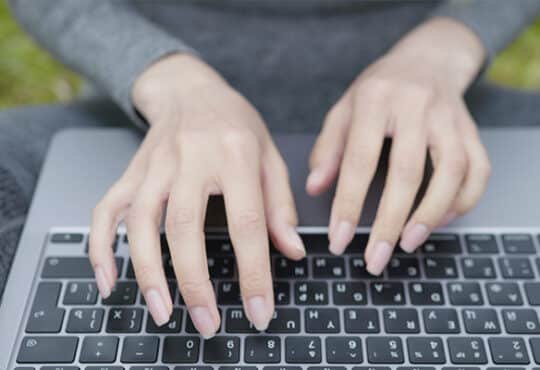 Person using laptop providing AI chatbot services online