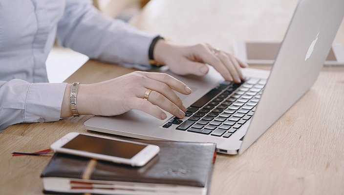 Minimal workspace with a laptop used for online micro-task work.